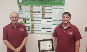 Luke Pruter, right, with his award for his poster. Standing with Pruter is Dr. Mike Brewer, left.